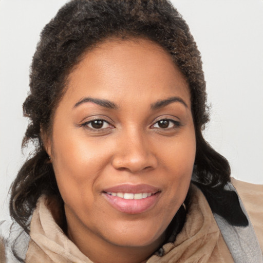 Joyful black young-adult female with medium  brown hair and brown eyes