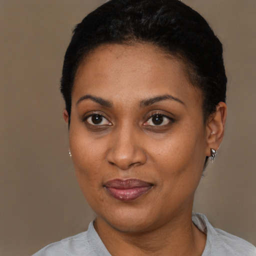 Joyful black young-adult female with short  brown hair and brown eyes