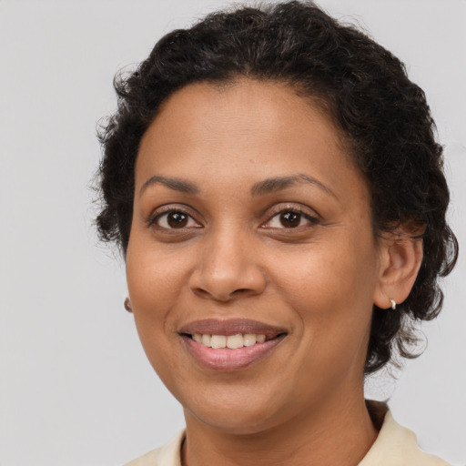 Joyful latino adult female with short  brown hair and brown eyes