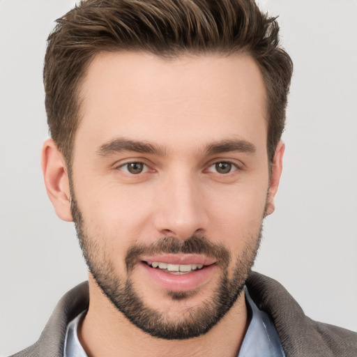 Joyful white young-adult male with short  brown hair and brown eyes