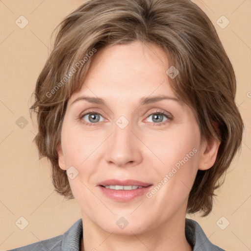 Joyful white adult female with medium  brown hair and grey eyes