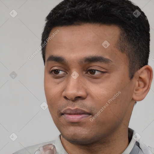 Joyful latino young-adult male with short  black hair and brown eyes