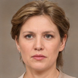 Joyful white adult female with medium  brown hair and grey eyes