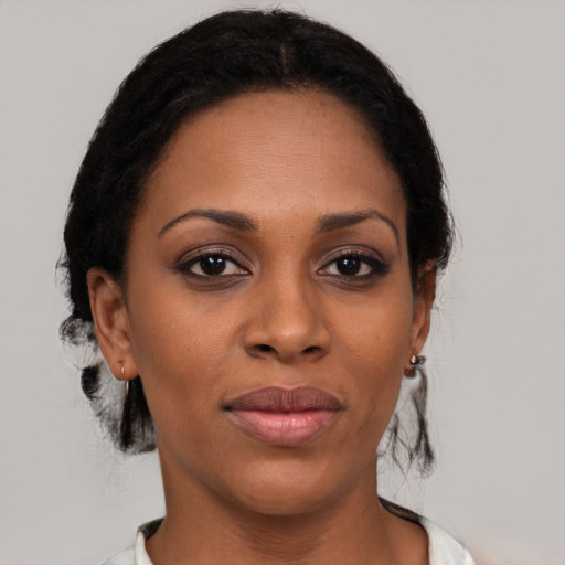 Joyful black young-adult female with short  black hair and brown eyes