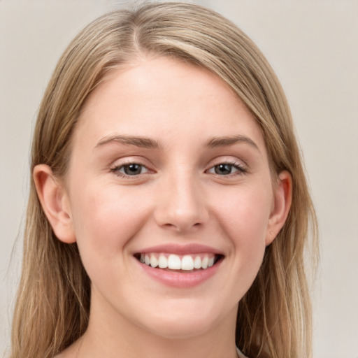 Joyful white young-adult female with long  brown hair and grey eyes