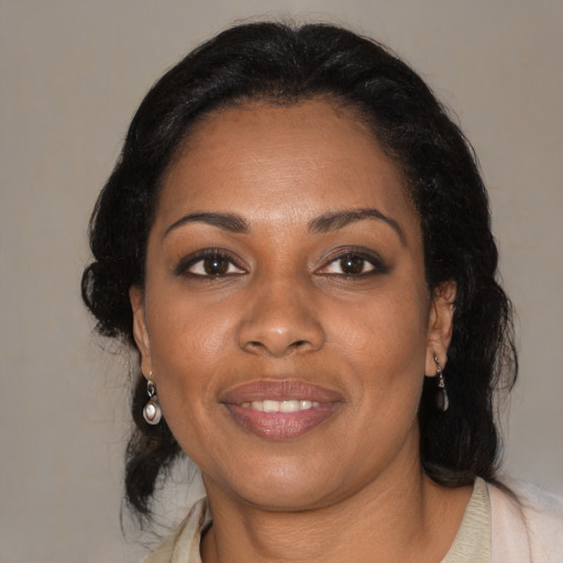 Joyful black adult female with medium  black hair and brown eyes
