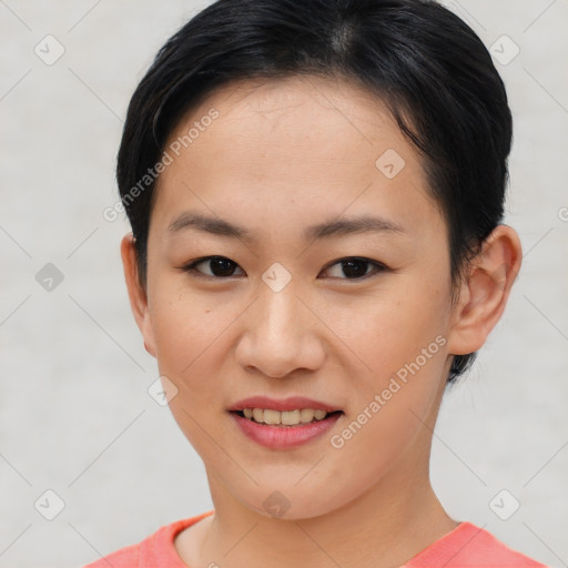 Joyful asian young-adult female with short  brown hair and brown eyes