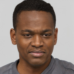 Joyful black young-adult male with short  brown hair and brown eyes