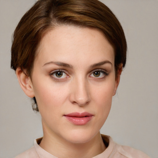 Joyful white young-adult female with short  brown hair and green eyes