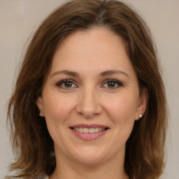 Joyful white adult female with medium  brown hair and brown eyes