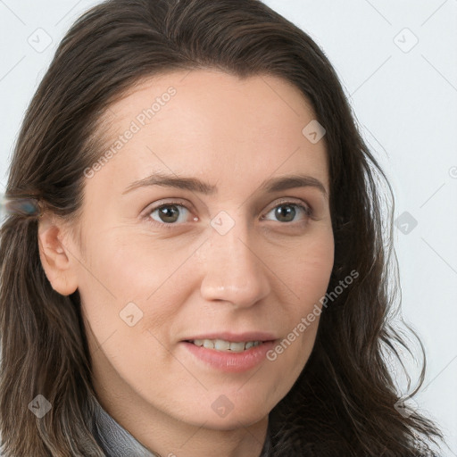 Joyful white young-adult female with long  brown hair and blue eyes