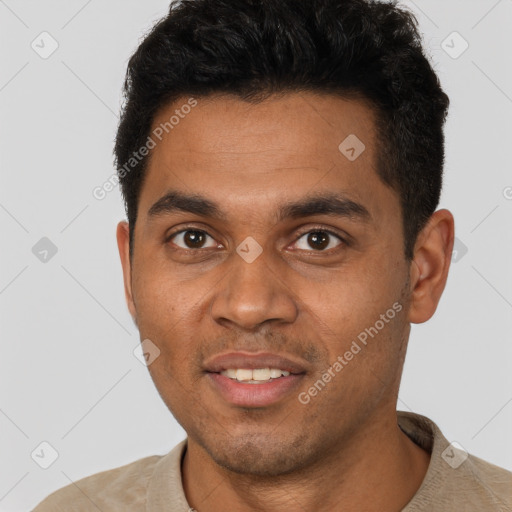 Joyful black young-adult male with short  brown hair and brown eyes