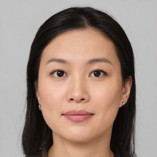 Joyful asian young-adult female with medium  brown hair and brown eyes