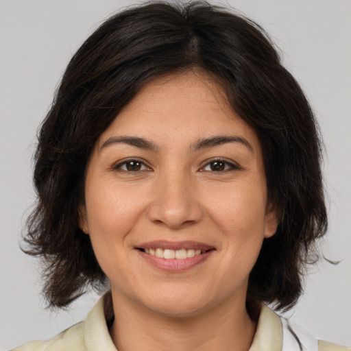 Joyful white young-adult female with medium  brown hair and brown eyes