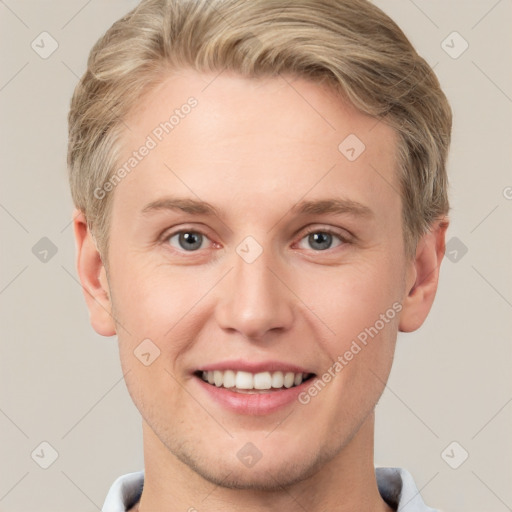 Joyful white young-adult male with short  brown hair and grey eyes