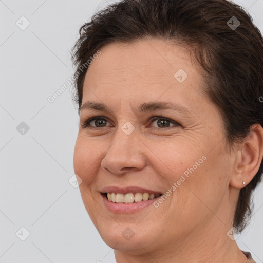 Joyful white adult female with medium  brown hair and brown eyes