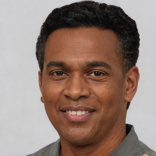 Joyful latino adult male with short  black hair and brown eyes