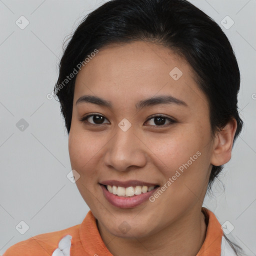 Joyful asian young-adult female with short  brown hair and brown eyes