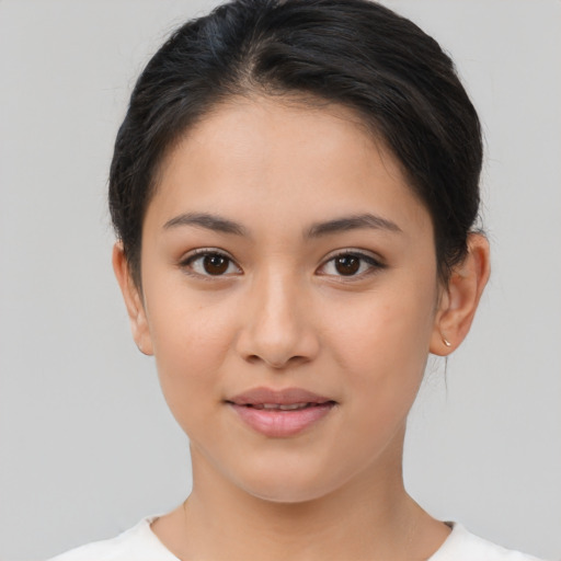 Joyful latino young-adult female with short  brown hair and brown eyes