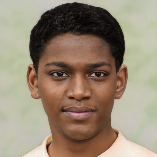 Joyful black child male with short  black hair and brown eyes
