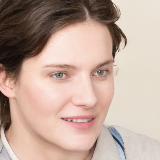 Joyful white young-adult female with medium  brown hair and blue eyes