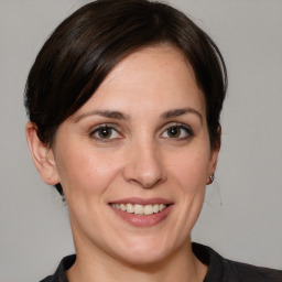 Joyful white adult female with medium  brown hair and grey eyes