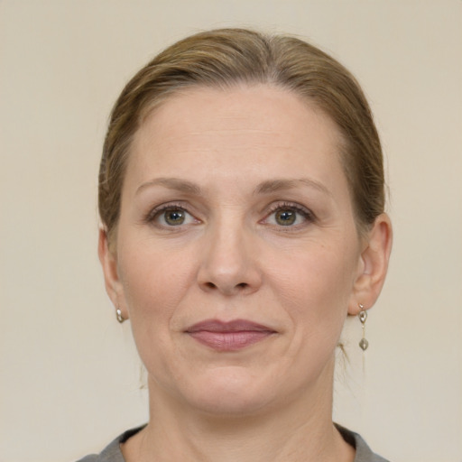 Joyful white adult female with medium  brown hair and grey eyes