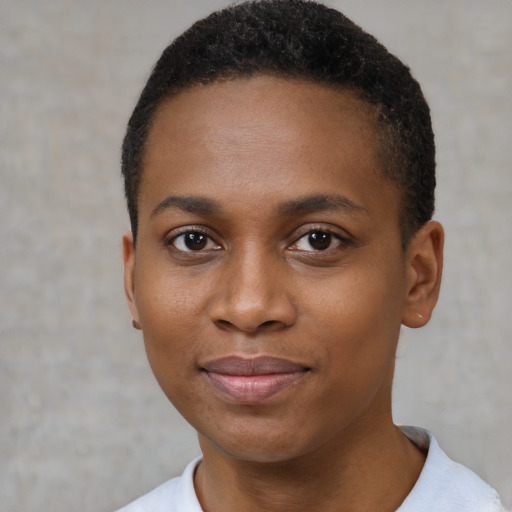 Joyful black young-adult female with short  black hair and brown eyes