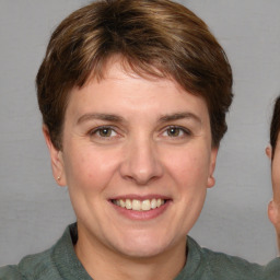 Joyful white adult female with short  brown hair and grey eyes