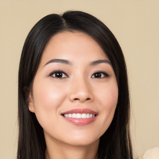 Joyful white young-adult female with long  black hair and brown eyes