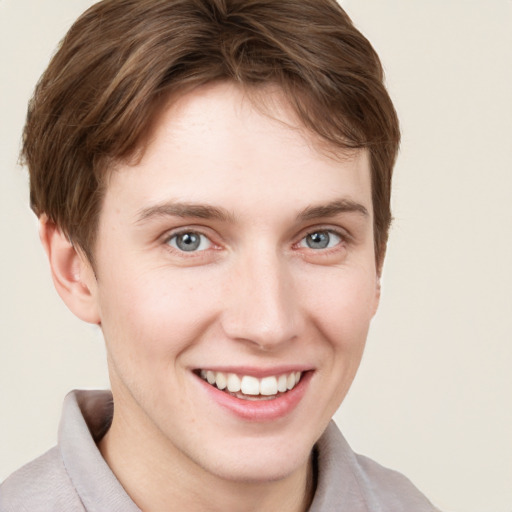 Joyful white young-adult female with short  brown hair and grey eyes