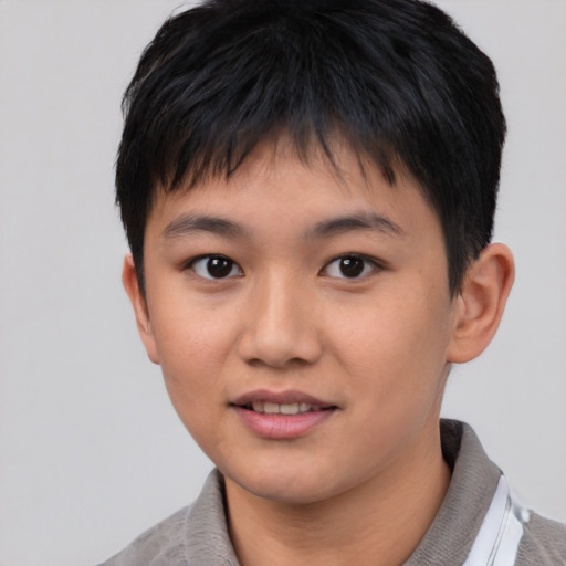 Joyful asian child male with short  brown hair and brown eyes