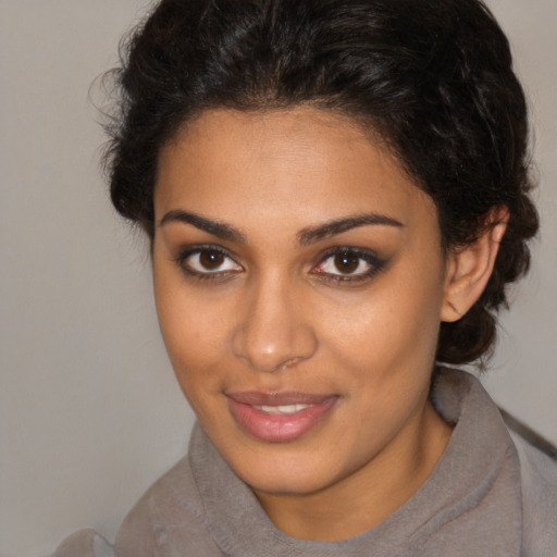 Joyful latino young-adult female with short  brown hair and brown eyes