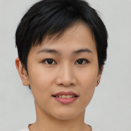 Joyful asian young-adult female with short  black hair and brown eyes