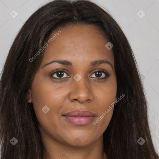 Joyful black young-adult female with long  brown hair and brown eyes