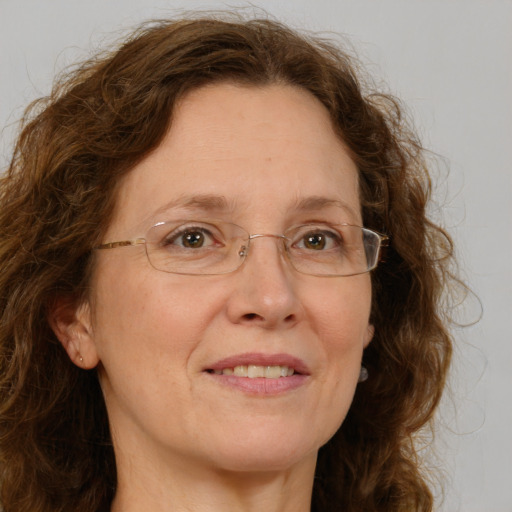 Joyful white adult female with long  brown hair and green eyes