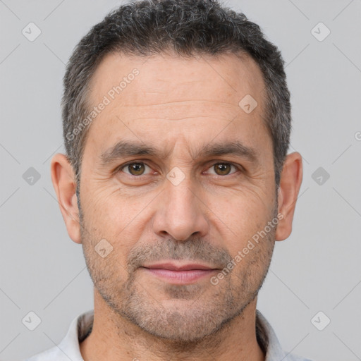 Joyful white adult male with short  brown hair and brown eyes