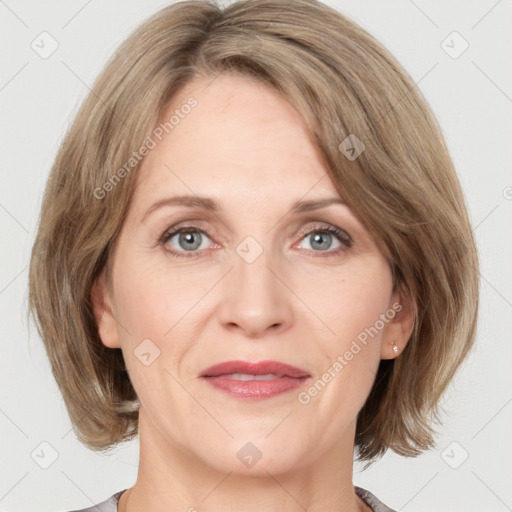 Joyful white adult female with medium  brown hair and grey eyes