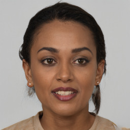 Joyful black young-adult female with short  brown hair and brown eyes