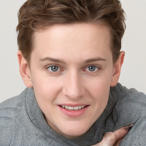 Joyful white young-adult female with short  brown hair and blue eyes