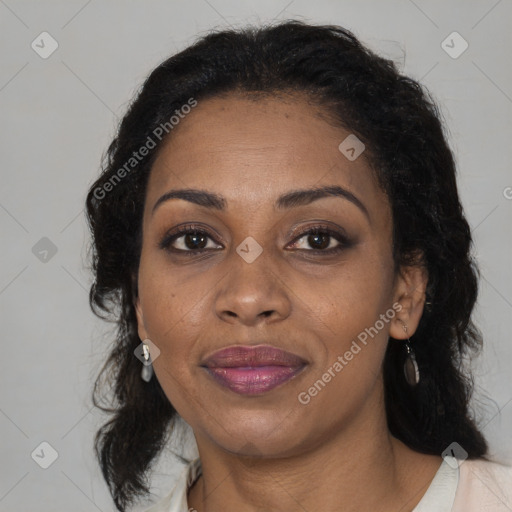 Joyful black adult female with medium  brown hair and brown eyes