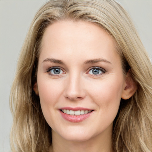 Joyful white young-adult female with long  brown hair and blue eyes