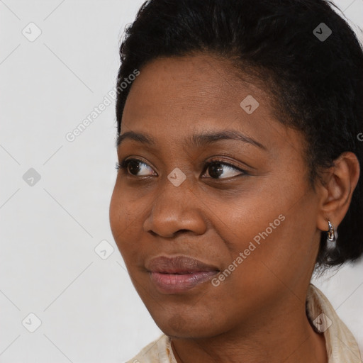 Joyful black young-adult female with short  black hair and brown eyes