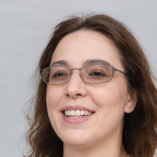 Joyful white adult female with long  brown hair and grey eyes