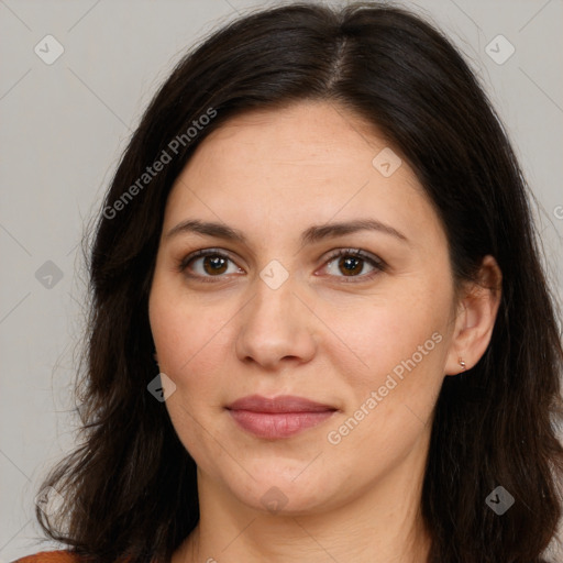 Joyful white adult female with long  brown hair and brown eyes