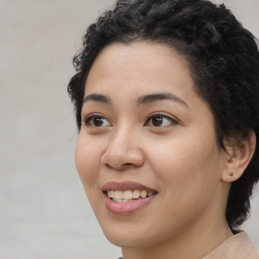 Joyful white young-adult female with medium  black hair and brown eyes