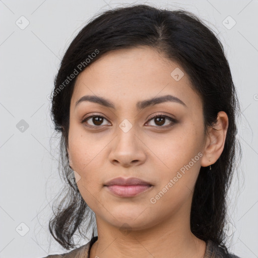 Joyful latino young-adult female with long  black hair and brown eyes