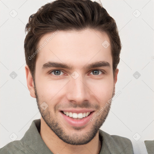 Joyful white young-adult male with short  brown hair and grey eyes