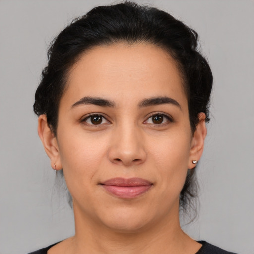 Joyful latino young-adult female with medium  brown hair and brown eyes