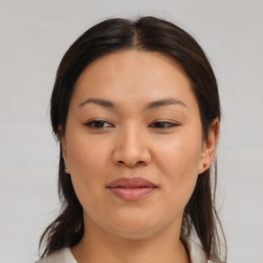 Joyful asian young-adult female with medium  brown hair and brown eyes